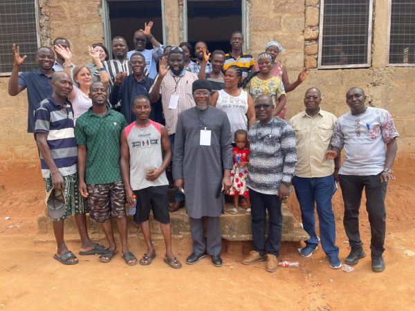 Summer school trainers, trainees and community focus group participants standing outside the church hall in Saforo, Ghana.